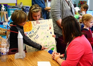 Superintendent getting a lesson from elementary students